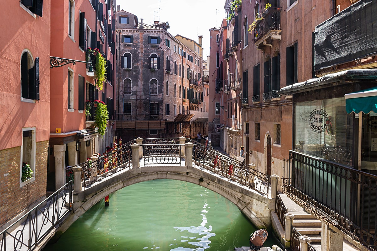 bridge-canal-by-buildings-city-min