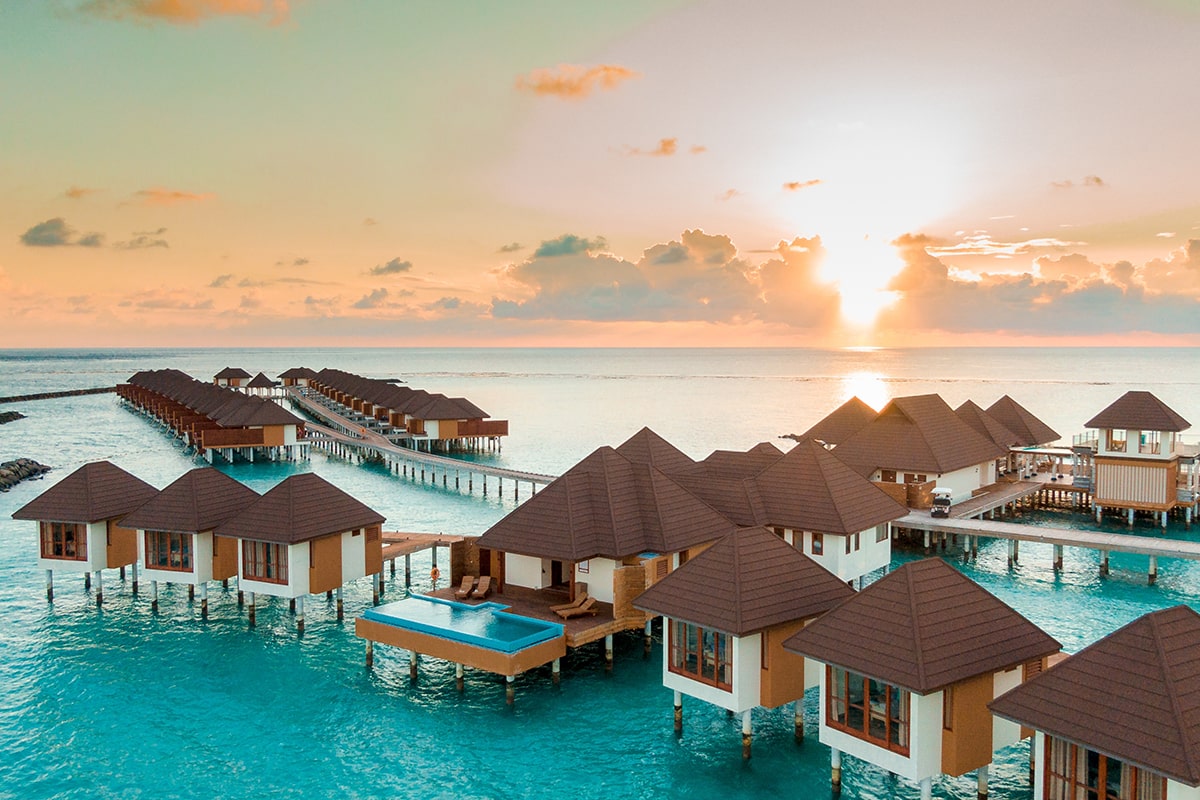 brown-white-wooden-houses-body-water-sunset-min