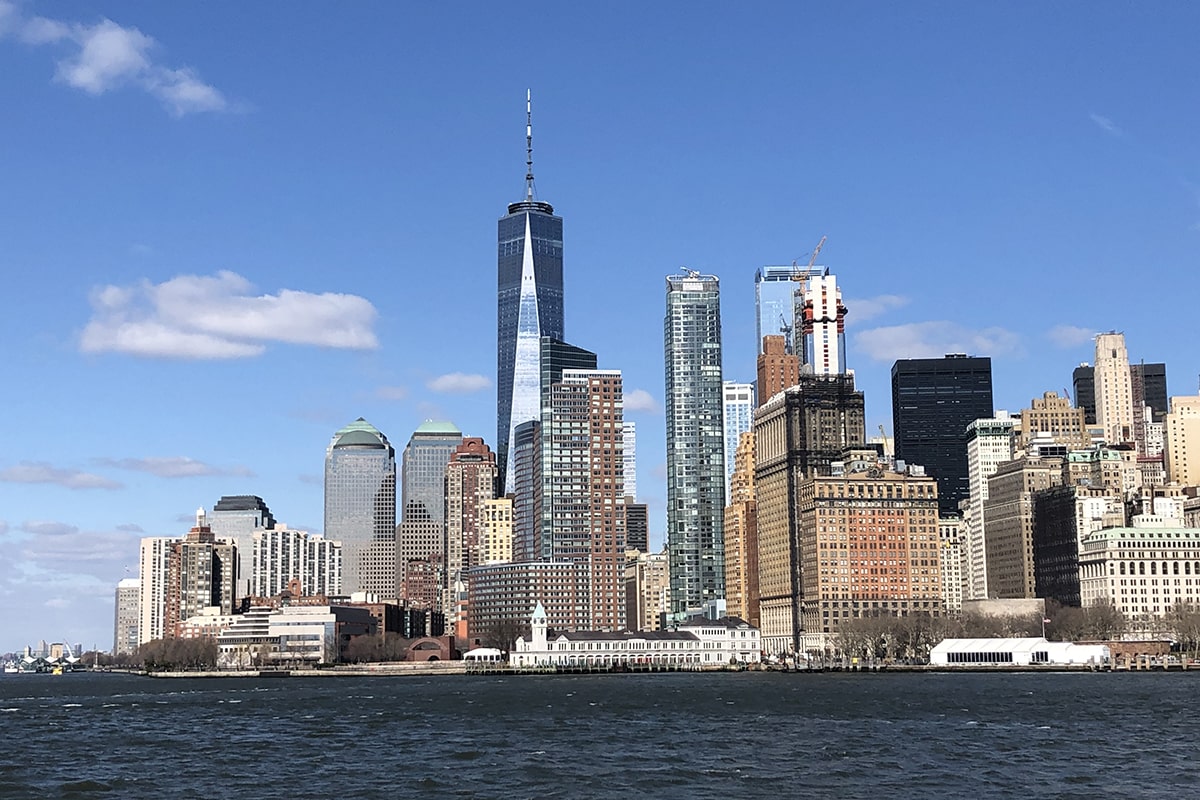 sea-by-buildings-against-sky-min